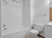 Thumbnail 14 of 27 - a bathroom with a toilet and a tub and a sink
