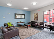 Thumbnail 19 of 35 - a living room with leather furniture and a large window