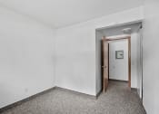 Thumbnail 13 of 43 - an empty room with white walls and a door to a hallway