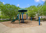 Thumbnail 31 of 57 - a playground with a swing set and a slide in a park