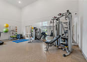 Thumbnail 25 of 53 - a home gym with weights and cardio equipment and a window