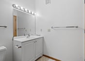 Thumbnail 12 of 27 - a bathroom with a sink and a mirror and a toilet