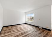Thumbnail 37 of 40 - the living room of an apartment with wood flooring and a window