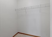 Thumbnail 13 of 27 - an empty room with a white wall and a wire rack on the ceiling
