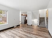 Thumbnail 4 of 40 - an empty living room with hardwood floors and a staircase