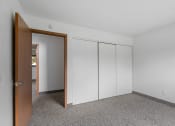 Thumbnail 11 of 43 - an empty room with white walls and a door to a closet
