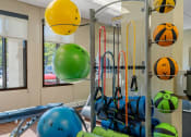 Thumbnail 9 of 51 - a fitness room with weights and cardio equipment in a building
