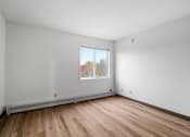 Thumbnail 15 of 25 - the living room of an empty house with wood floors and a window
