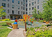 Thumbnail 49 of 53 - a playground in a park with benches and a fire hydrant