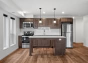 Thumbnail 29 of 36 - a kitchen with wooden cabinets and stainless steel appliances
