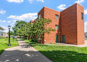 Thumbnail 6 of 25 - a red brick building with a sidewalk in front of it