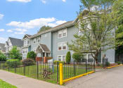 Thumbnail 15 of 31 - a row of houses with a fence in front of a sidewalk