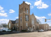 Thumbnail 32 of 45 - a church with a clock tower on the side of a street