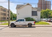 Thumbnail 51 of 67 - a white truck parked on the street in a parking lot