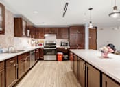 Thumbnail 23 of 55 - a large kitchen with wooden cabinets and white counter tops