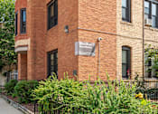 Thumbnail 25 of 67 - a brick building with a sign on the side of it