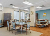 Thumbnail 3 of 51 - a dining room with tables and chairs and a wall with surfboards