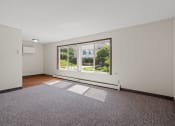 Thumbnail 25 of 57 - a living room with a large window and a rug