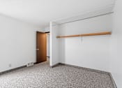 Thumbnail 36 of 40 - an empty room with a white wall and a door to a closet