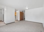 Thumbnail 6 of 43 - an empty living room with white walls and a carpeted floor