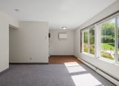 Thumbnail 24 of 57 - a living room with large windows and a rug