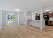 Thumbnail 9 of 53 - an empty kitchen and living room with a large window