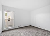 Thumbnail 8 of 40 - an empty room with a window and a carpet