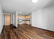 Thumbnail 8 of 26 - a view of a kitchen and a living room with a hard wood floor
