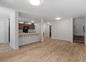 Thumbnail 6 of 53 - an empty living room with a kitchen and stairs