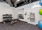 Thumbnail 38 of 55 - a gym with weights and a toilet and a mirror