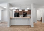 Thumbnail 7 of 53 - an empty kitchen with a sink and a refrigerator
