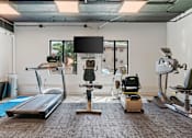 Thumbnail 51 of 55 - a fitness room with treadmills and other exercise equipment