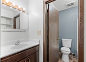 Thumbnail 9 of 40 - a bathroom with a toilet and a sink and a mirror