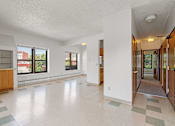 Thumbnail 22 of 67 - the living room and entryway of an empty house with large windows