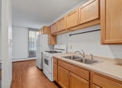 Thumbnail 20 of 51 - a kitchen with white appliances and wooden cabinets