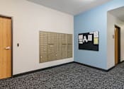 Thumbnail 31 of 35 - a wall of mailboxes in a room with a door