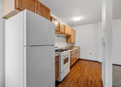 Thumbnail 46 of 51 - a kitchen with wood flooring and white appliances