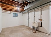 Thumbnail 10 of 40 - the basement of a house with a sink in the corner