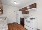 Thumbnail 20 of 57 - a kitchen with white appliances and wood flooring