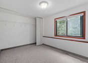 Thumbnail 41 of 43 - the living room of an empty house with a large window