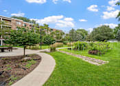 Thumbnail 15 of 25 - a park with grass and trees and a sidewalk