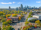 Thumbnail 15 of 27 - Aerial view of Karinsplass Apartments with the Minneapolis Skyline behind it.