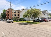 Thumbnail 50 of 67 - a white truck driving down a street in front of a brick building