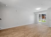 Thumbnail 10 of 53 - a living room with white walls and a window