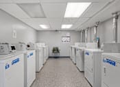 Thumbnail 52 of 55 - a room filled with washers and dryers and a chair
