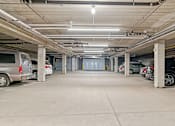 Thumbnail 17 of 35 - a parking garage with cars parked in it