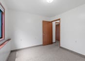 Thumbnail 40 of 43 - an empty room with white walls and a wooden door