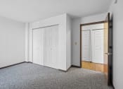 Thumbnail 2 of 51 - an empty room with white walls and a door to a bedroom
