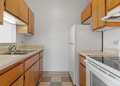 Thumbnail 64 of 67 - a kitchen with wooden cabinets and a sink and a refrigerator