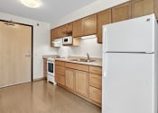 Thumbnail 9 of 52 - a kitchen with wooden cabinets and a white refrigerator